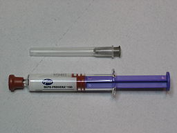 Depo-Provera shot with a syringe next to a small vial of medicine