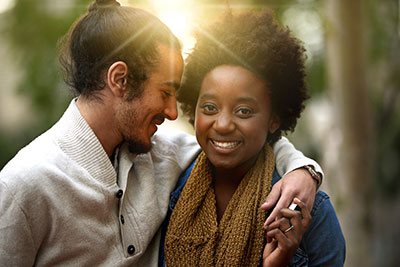 A man and woman holding hands and smiling