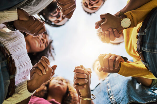 Cropped shot of a group of people holding hands