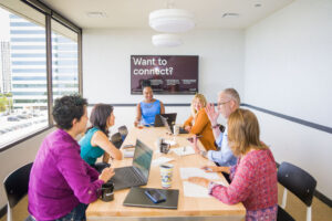 Six CAPTC staff members sitting around a conference table in discussion