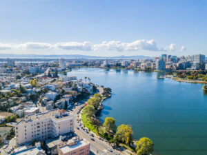 Aerial view above Lake Merritt in Oakland, California. Looking across the lake at downtown Oakland with skyscrapers in the distance.