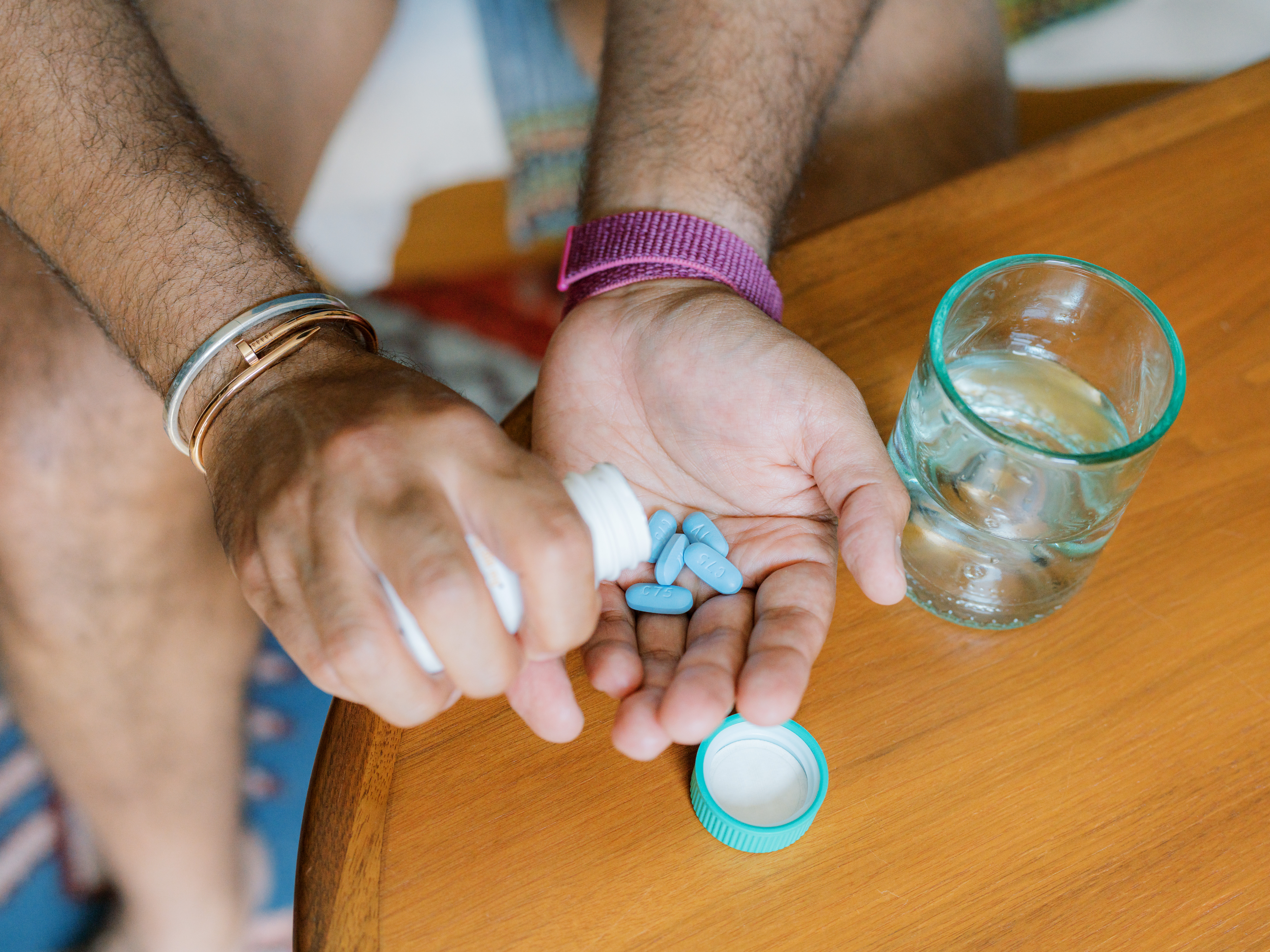 person holding blue pills