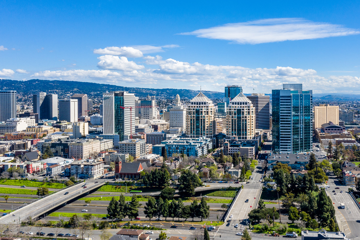 An aerial view of the downtown Oakland skyline on a clear sunny day.